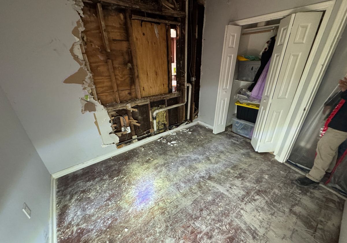 Interior demolition exposing framing and plumbing